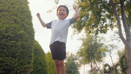 Exited asian boy jumping and dances. Happy family concept
