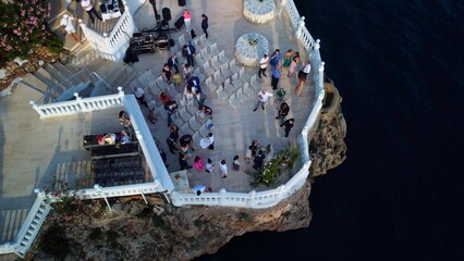 Top view of beginning of wedding ceremony on the cliff. Drone aerial view