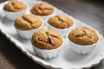 Sweet muffins freshly baked on modern white plate