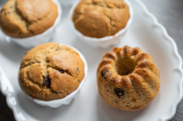 Yummy muffins with chocolate pieces on white plate