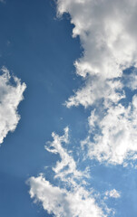 Clouds in the blue sky .
