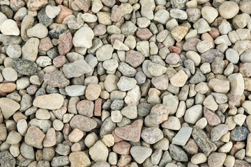 Pile of grey stones as background, top view