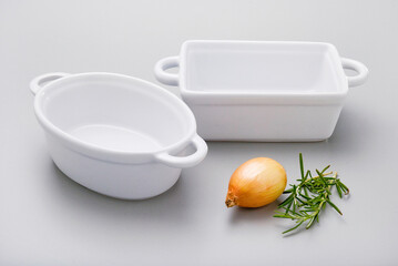 Kit of oval and rectangular white ceramic empty food containers, isolated on white