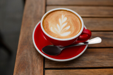 Cup of aromatic coffee on wooden table