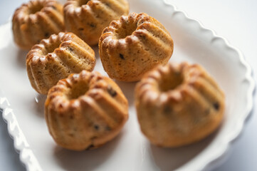 Tasty muffins on nice plate on table at birthday party