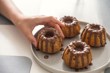 Childs hand taken with chocolate glaze yummy handmade muffins