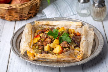 Traditional Turkish food; Meat with vegetables wrapped in greaseproof paper, kebab (Turkish name; Sebzeli kagit kebabi)
