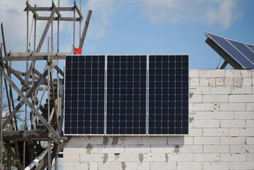 Installation of solar panels house under construction, green energy concept