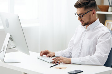 businessmen wearing glasses sits at a desk office worked executive