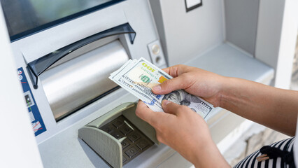 Atm card machine cash. Holding american bill cash. Woman withdraw money usd hundred dollar. Bank credit card money background.