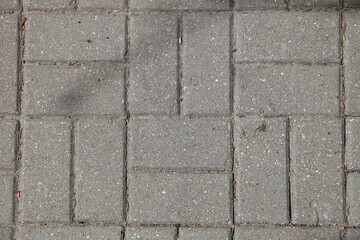 Obraz premium Paving of streets with gray paving slabs. Improvement of the city. Background texture.