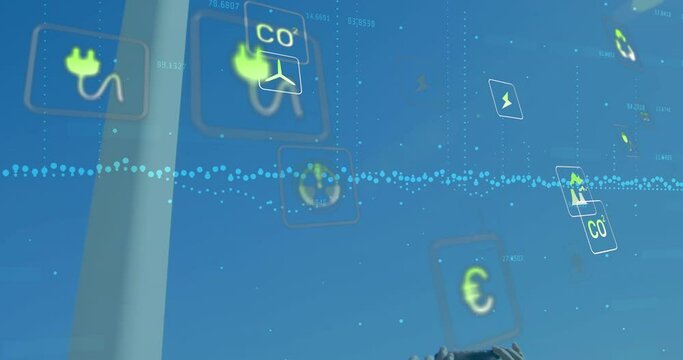 Animation of falling eco icons over windmill