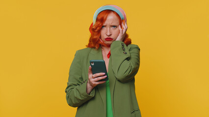 Displeased sad redhead young woman use smartphone typing browsing, loses becoming surprised sudden...