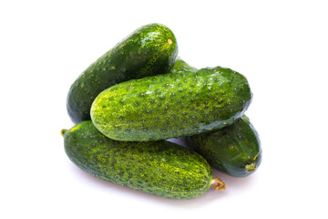 green cucumbers lie on a white background