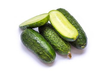 green cucumbers lie on a white background