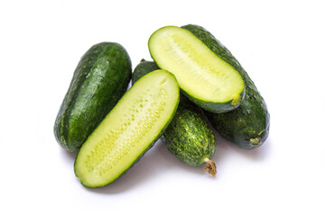 green cucumbers lie on a white background
