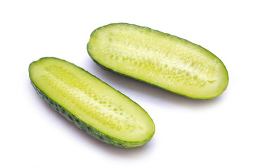 two halves of cucumber lie on a white background