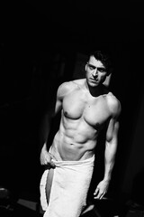 Fototapeta na wymiar Muscular male model poses in black and white artistic photos