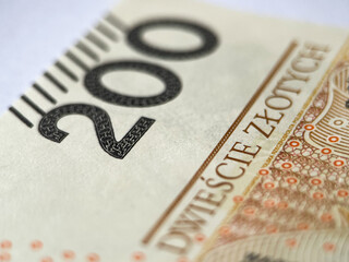A 200 zloty bill in close-up on a white isolated background. Polish currency