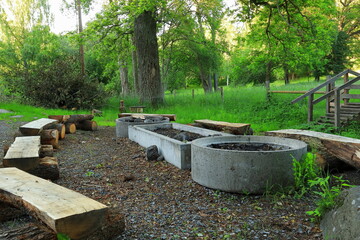 One public fireplace. Summer time, ready for barbeque party. Wooden benches. Stockholm, Sweden, Europe.