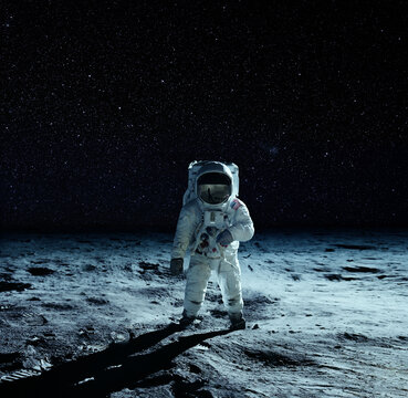 Astronaut at the spacewalk on the moon. National Moon Day. Elements of this image furnished by NASA.