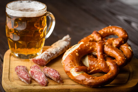 traditional mug of beer, pretzels and fuet sausage