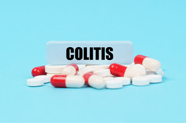 On the blue surface of the pills, capsules and a plate with the inscription - COLITIS