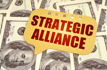 On the dollars is a sign with the inscription - strategic alliance