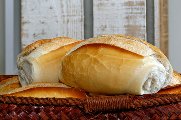 French bread basket on rustic wooden background