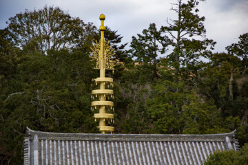 golden tower architecture rising above the forest