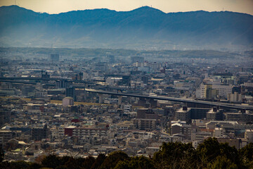 view of a busy cityscape with a raised rail track