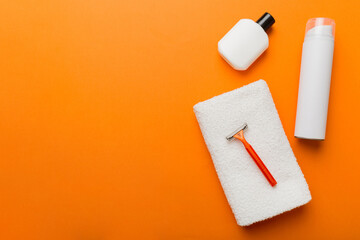 shaving man set. shaving machine, towel, lotion and shaving foam on colored background. Men bath Accessories top view