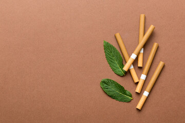 Menthol cigarettes and fresh mint leaves on colored background, Many cigarettes stacked together top view flat lay