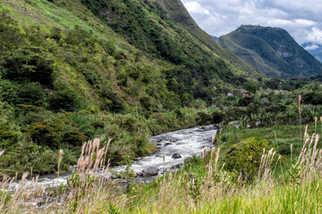 Horizontal shot of river between green mountains