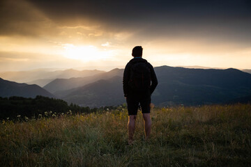 man in nature looking at sunset