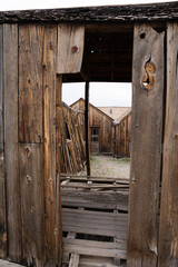 Antique Mining Town In Bodie State Historic Park. Vintage Buildings And Old Mining Equipment Still Standing In Good Condition.