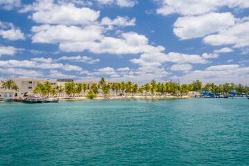 Naklejka na ściany i meble Boats near the coast with palms of Isla Mujeres island in Caribbean Sea, Cancun, Yucatan, Mexico