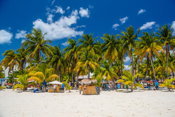 Cocos beach bar on a beach with white sand and palms on a sunny day, Isla Mujeres island, Caribbean...