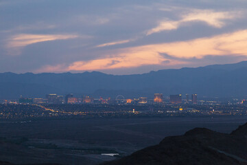 Clouds light the sky in blue flame after the desert sun sets over the Las Vegas Nevada USA city skyline