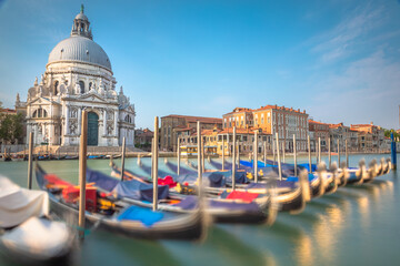 Row of Gondolas in Grand Canal of Venice with blurred movement, Italy