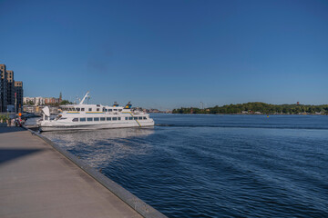 A commuter boat arriving from the archipelago in the bay Saltsj&ouml;n, a sunny summer day in Stockholm