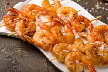 tiger shrimp kebabs on white plate, canapes