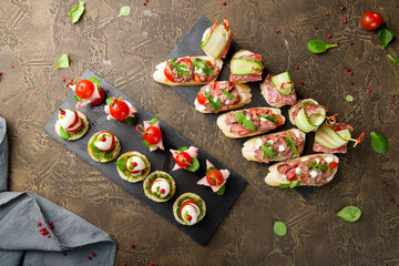 Bruschetta with roast beef and assorted canapes on table top view