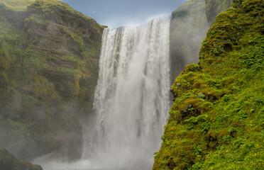 Skógar, Iceland - July 3, 2022 A closeup of Skógafoss, a waterfall on the Skógá River in the south of Iceland at the cliff marking the former coastline.