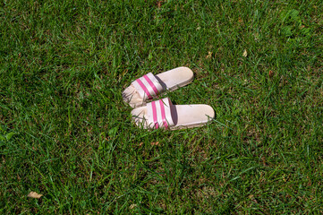 Women's slippers are on the grass