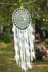 Dreamcatcher hanging on a tree. Boho chic, ethnic amulet, symbol