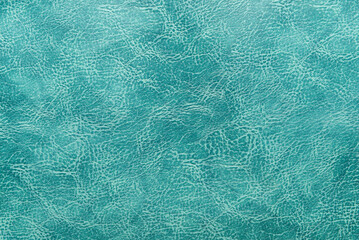 Green leather texture background.  Blank wallpaper for your design.