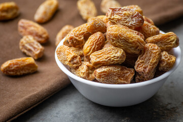 Indian dry dates in white bowl