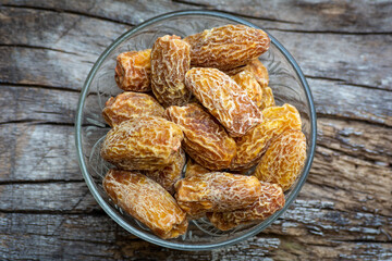 Indian dry dates in green bowl