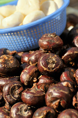 Water chestnuts being peeled at the market in Asia